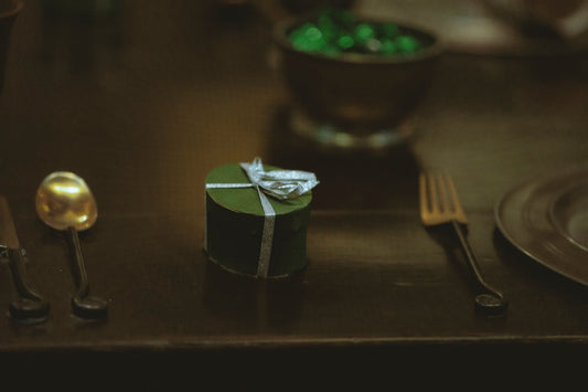 silver fork beside green and white box