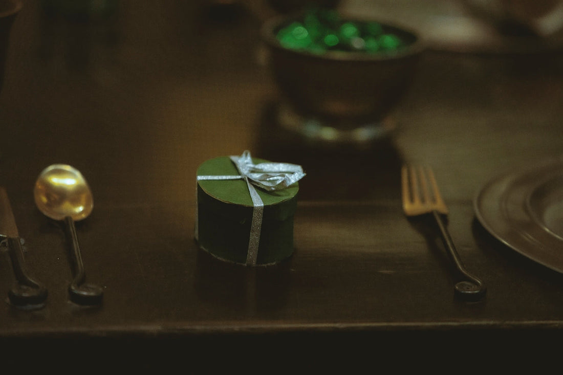 silver fork beside green and white box